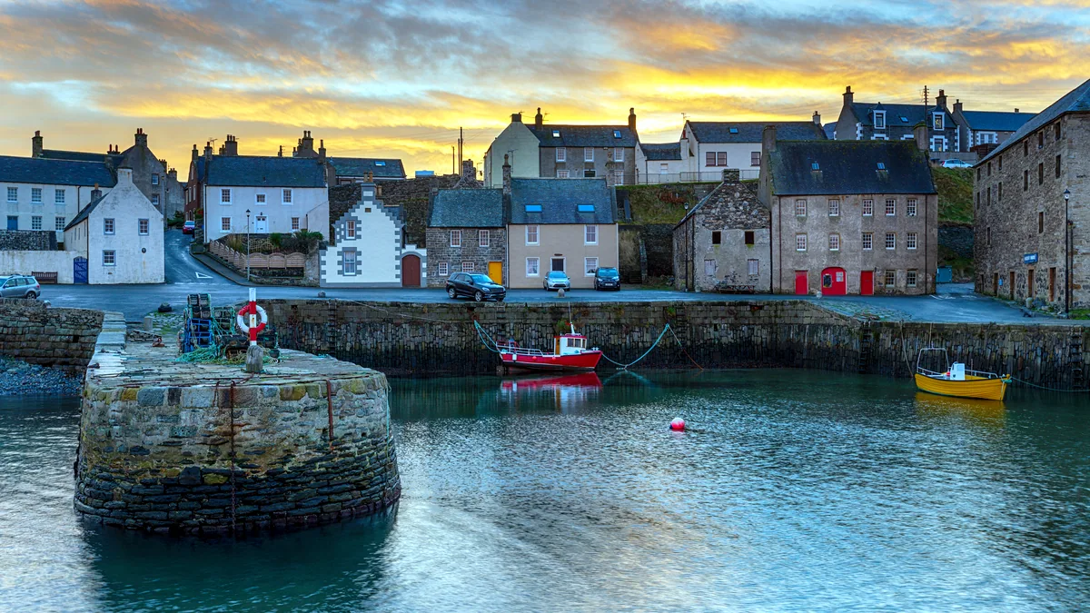 Boats resting in Bangor harbour in the light of early dawn.