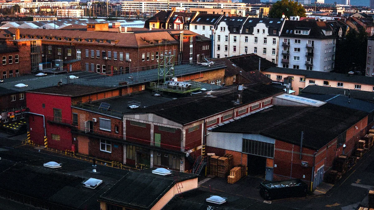 Old industrial buildings in Huddersfield glowing under evening light.