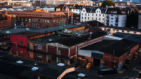 Old industrial buildings in Huddersfield glowing under evening light.